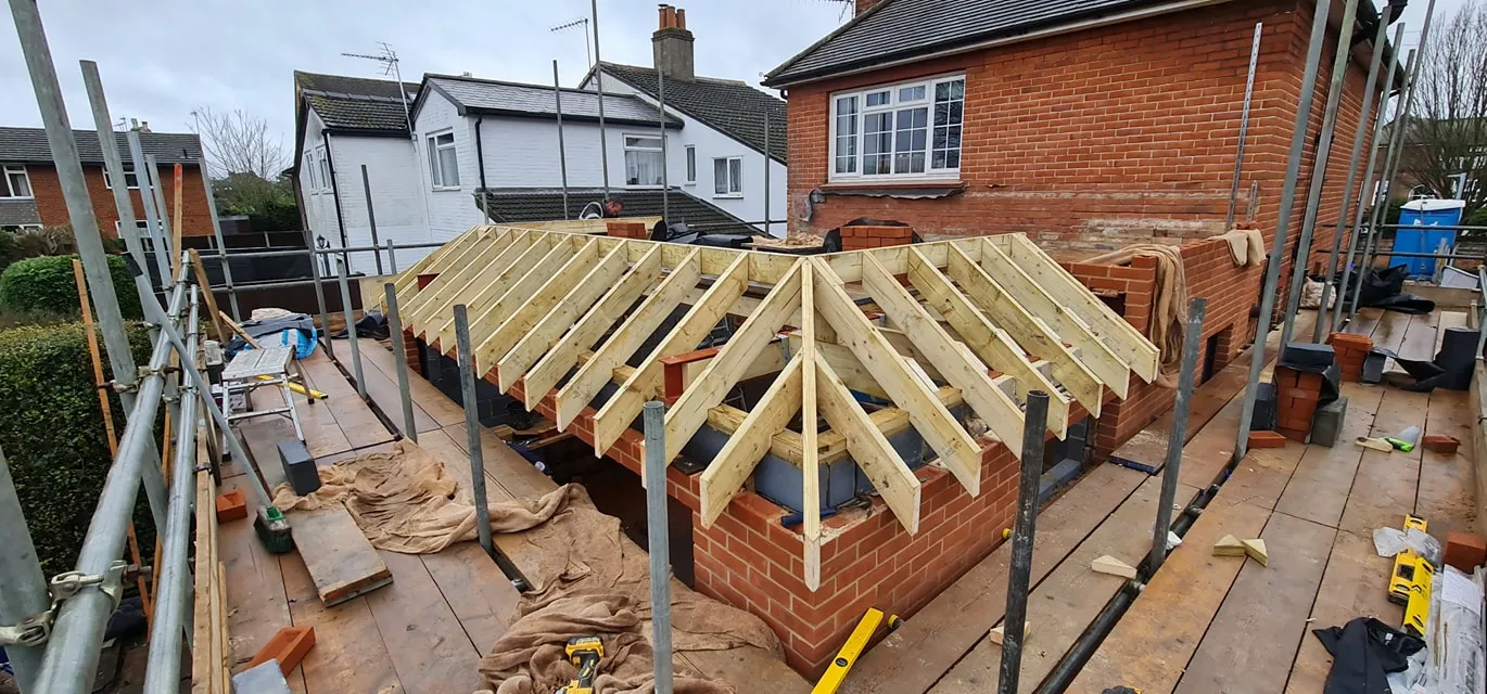 A house being built with a wooden roof.