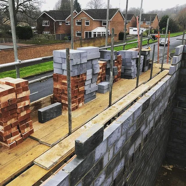 A pile of bricks sitting on top of a wooden platform.