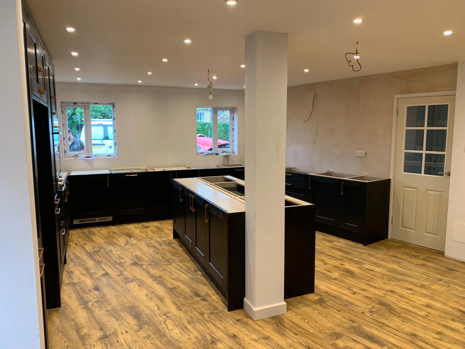 A large kitchen with a center island in the middle of the room.